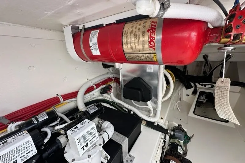 Slide: The Image of Engine compartment of 2021 Tiara Sport 43 LS with fire extinguisher and wiring. - 57