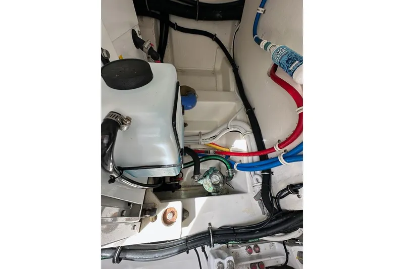 Slide: The Image of Engine compartment of a 2021 Tiara Sport 43 LS with visible hoses and components. - 60