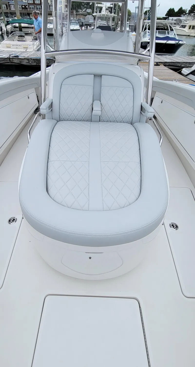 Slide: The Image of 2023 Mag Bay 33 CC boat with luxurious seating at a marina. - 17