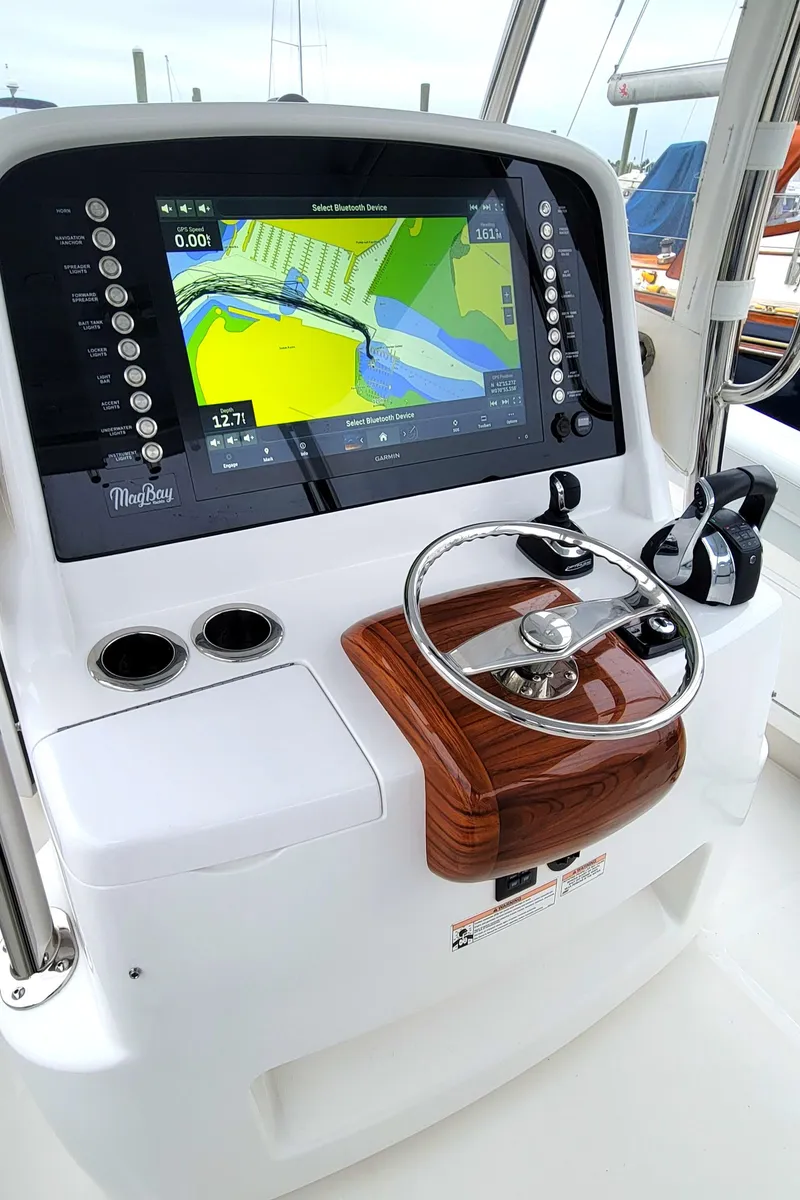 Slide: The Image of 2023 Mag Bay 33 CC helm with navigation display and steering wheel. - 22