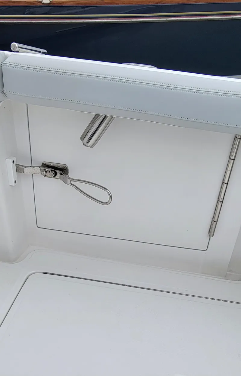 Slide: The Image of 2023 Mag Bay 33 CC boat interior detail with white upholstery and stainless steel hardware. - 33