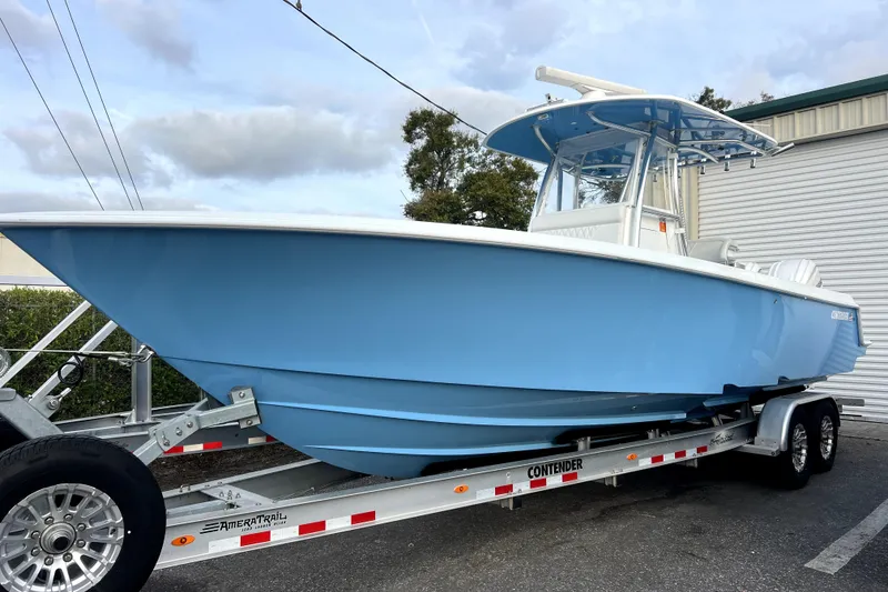 The Image of 2023 Contender 30 ST boat in light blue on trailer, parked outdoors. - 0