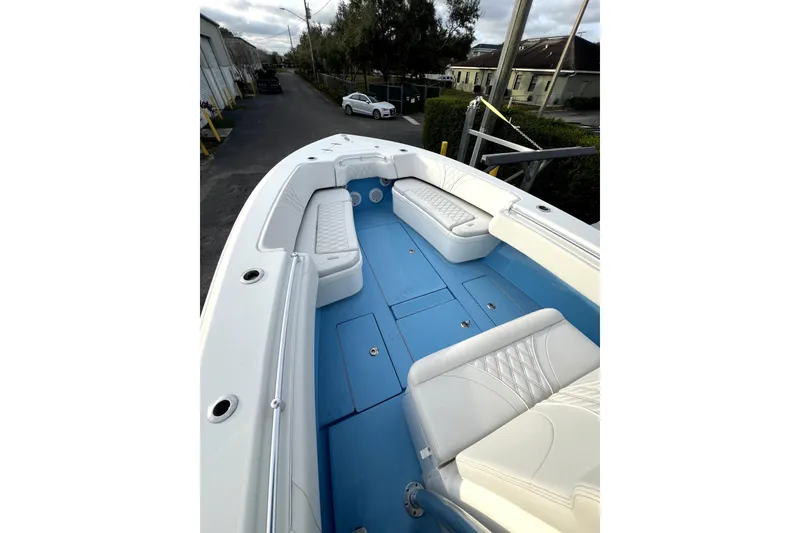 Slide: The Image of 2023 Contender 30 ST boat interior with white seating and blue deck. - 10