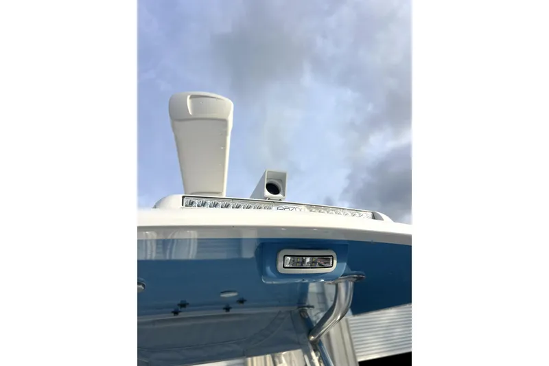 Slide: The Image of 2023 Contender 30 ST boat with radar and lighting against cloudy sky. - 13