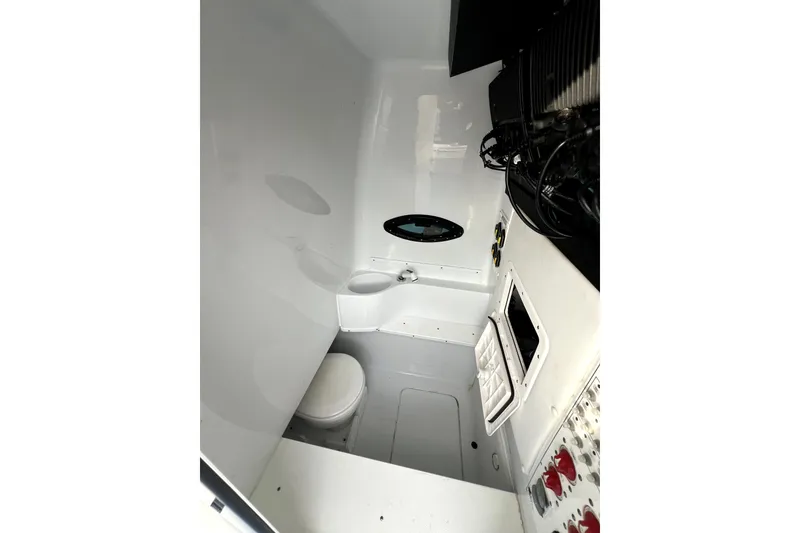 Slide: The Image of 2023 Contender 30 ST boat interior with compact bathroom and modern fixtures. - 14