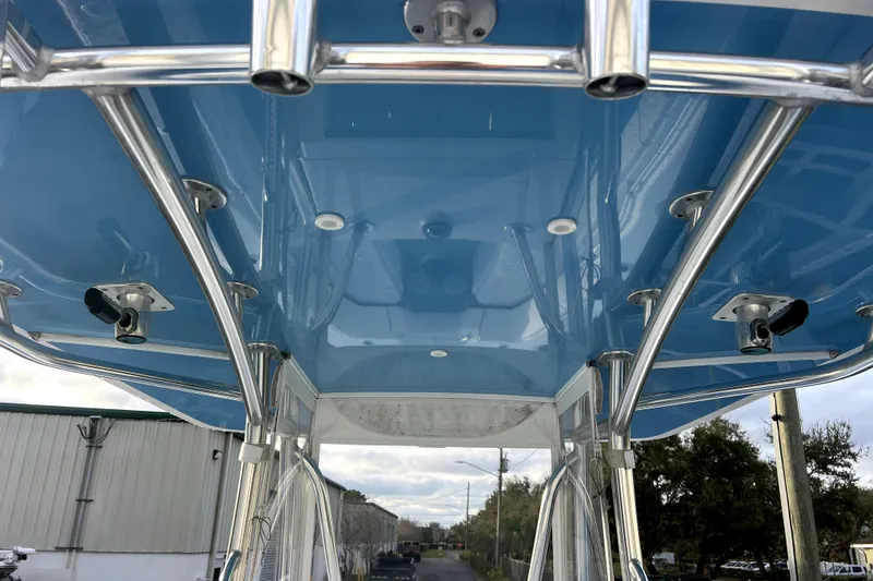 Slide: The Image of 2023 Contender 30 ST boat with blue T-top and stainless steel supports. - 15