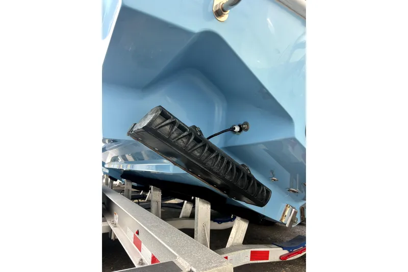 Slide: The Image of 2023 Contender 30 ST boat hull on trailer, showcasing sleek design and trim tab. - 16