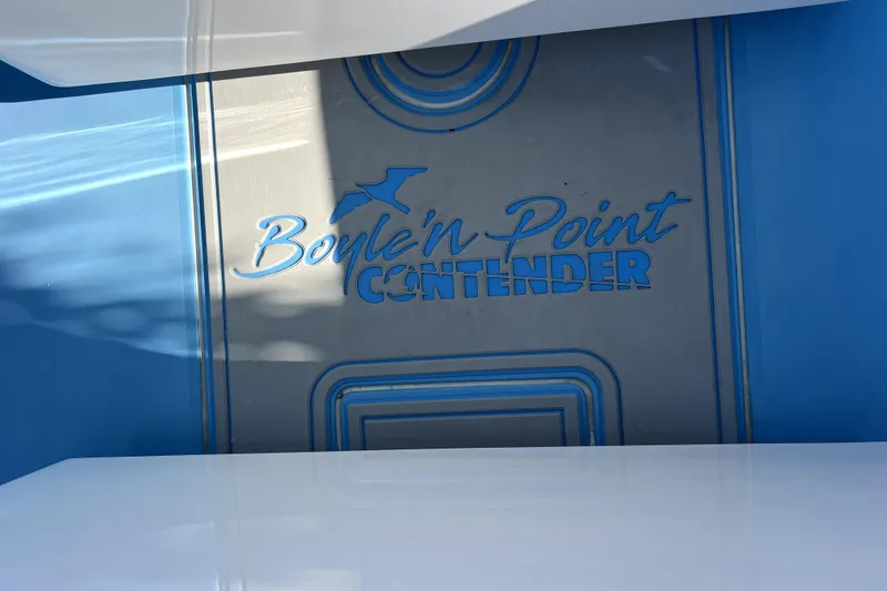 Slide: The Image of 2023 Contender 30 ST boat with "Boyle'n Point" branding on a blue and gray surface. - 23