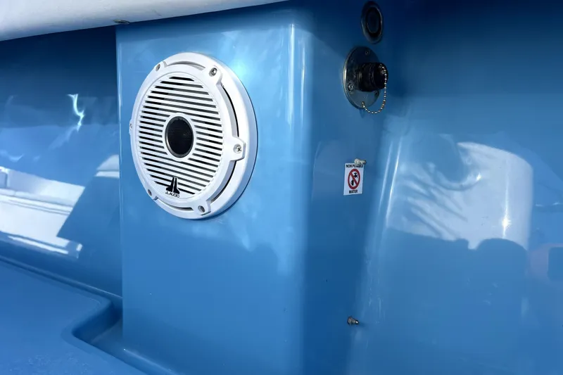 Slide: The Image of 2023 Contender 30 ST boat interior with speaker and water warning label. - 24