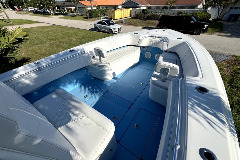Slide: The Image of 2023 Contender 30 ST boat interior with white seating and blue flooring. - 25