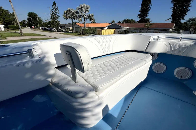 Slide: The Image of 2023 Contender 30 ST boat interior with white seating and blue flooring. - 26