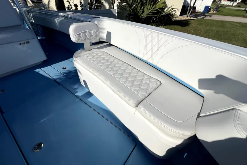 Slide: The Image of 2023 Contender 30 ST boat interior with white cushioned seating and blue flooring. - 29