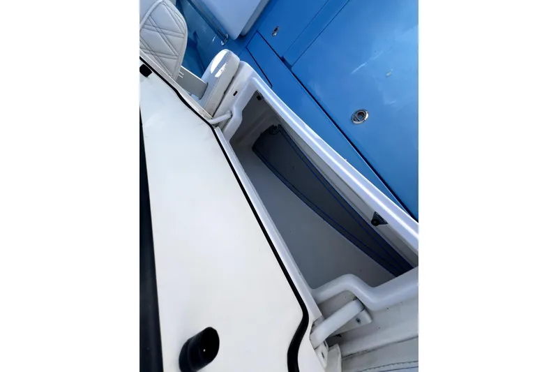 Slide: The Image of 2023 Contender 30 ST boat interior storage compartment with blue accents. - 30