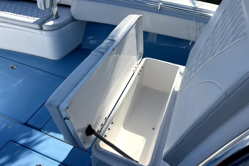 Slide: The Image of Open storage compartment on 2023 Contender 30 ST boat with blue deck. - 31