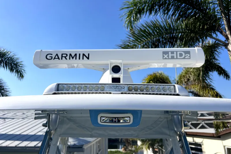Slide: The Image of 2023 Contender 30 ST boat with Garmin xHD2 radar, palm trees in background. - 32