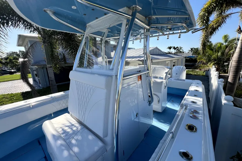 Slide: The Image of 2023 Contender 30 ST boat with sleek design, white seating, and modern console. - 33