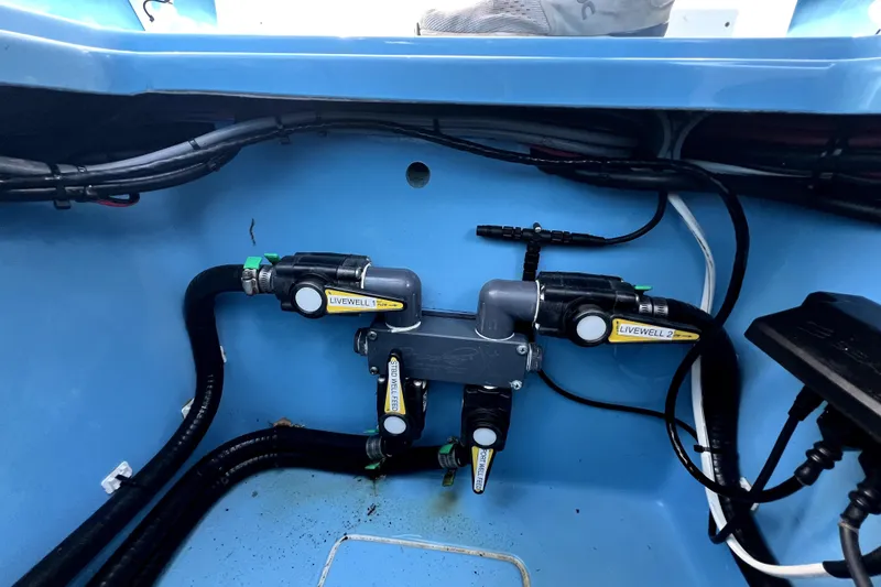 Slide: The Image of 2023 Contender 30 ST boat livewell plumbing system with labeled valves and hoses. - 37