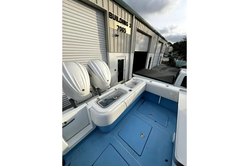 Slide: The Image of 2023 Contender 30 ST boat with dual engines, parked outside Building 3. - 4