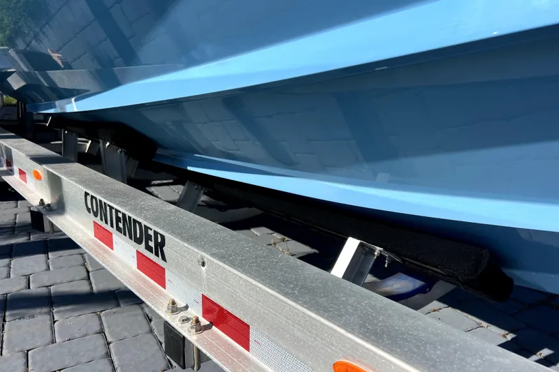 Slide: The Image of 2023 Contender 30 ST boat on trailer, close-up view of hull and branding. - 45