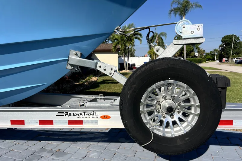 Slide: The Image of Trailer with Contender 30 ST boat, AmeraTrail branding, parked on paved driveway, sunny day. - 47