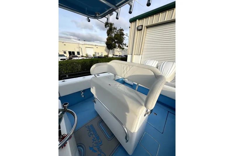 Slide: The Image of 2023 Contender 30 ST boat interior with white seating and blue flooring. - 7