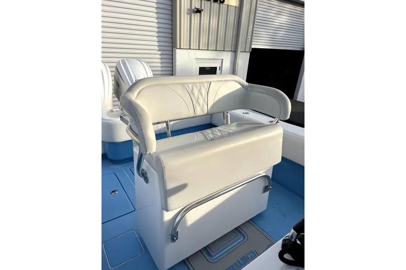Slide: The Image of 2023 Contender 30 ST boat seat with white upholstery and stainless steel accents. - 8