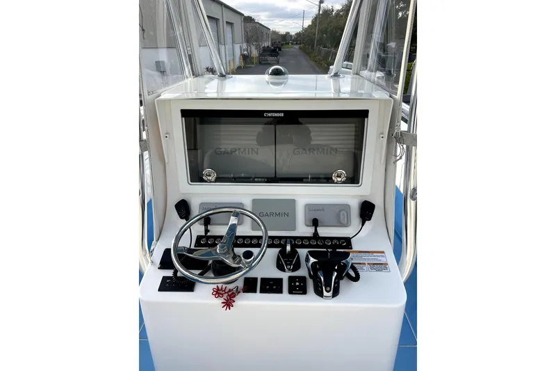 Slide: The Image of 2023 Contender 30 ST boat console with Garmin navigation system and steering wheel. - 9