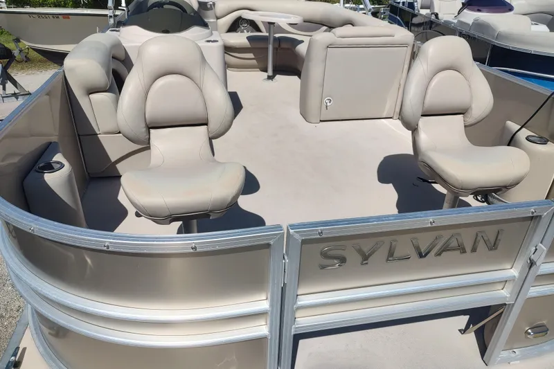 Slide: The Image of 2016 Sylvan Mirage Fish 8522 Party Fish boat interior with beige seating. - 10