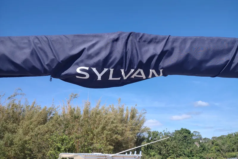 Slide: The Image of Blue cover with "Sylvan" logo on a 2016 Mirage Fish 8522 Party Fish boat. - 11