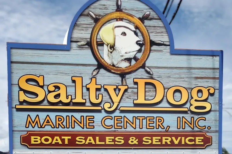 Slide: The Image of Salty Dog Marine Center sign for boat sales and service, featuring a nautical dog logo. - 14