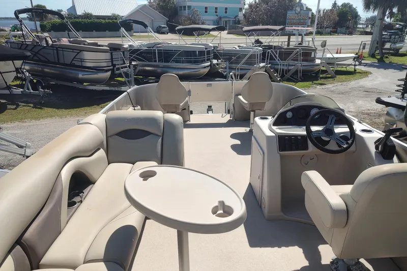 Slide: The Image of 2016 Sylvan Mirage Fish 8522 Party Fish 4.0 pontoon boat interior with seating and steering console. - 4