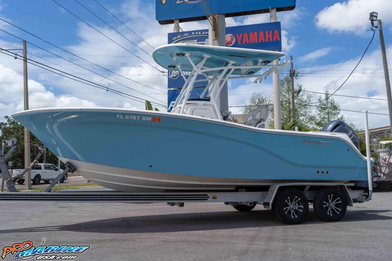 Slide: The Image of 2021 Sea Fox 228 Commander boat on trailer, displayed outdoors with Yamaha signage. - 0
