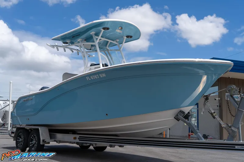 Slide: The Image of 2021 Sea Fox 228 Commander boat on trailer under blue sky. - 1