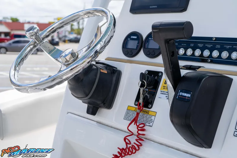 Slide: The Image of Steering wheel and controls of a 2021 Sea Fox 228 Commander boat. - 13