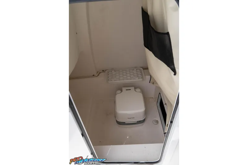 Slide: The Image of 2021 Sea Fox 228 Commander boat interior with portable toilet and storage compartment. - 17
