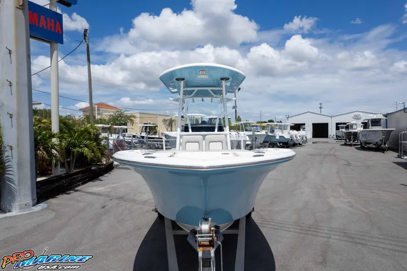 Slide: The Image of 2021 Sea Fox 228 Commander boat displayed outdoors at a dealership under a blue sky. - 25