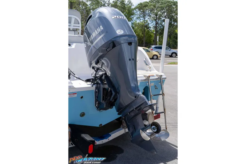 Slide: The Image of 2021 Sea Fox 228 Commander with Yamaha outboard motor in a parking lot. - 28