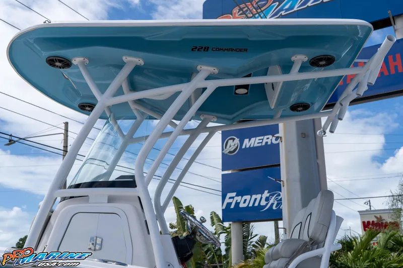 Slide: The Image of 2021 Sea Fox 228 Commander boat with T-top and seating, displayed outdoors. - 32