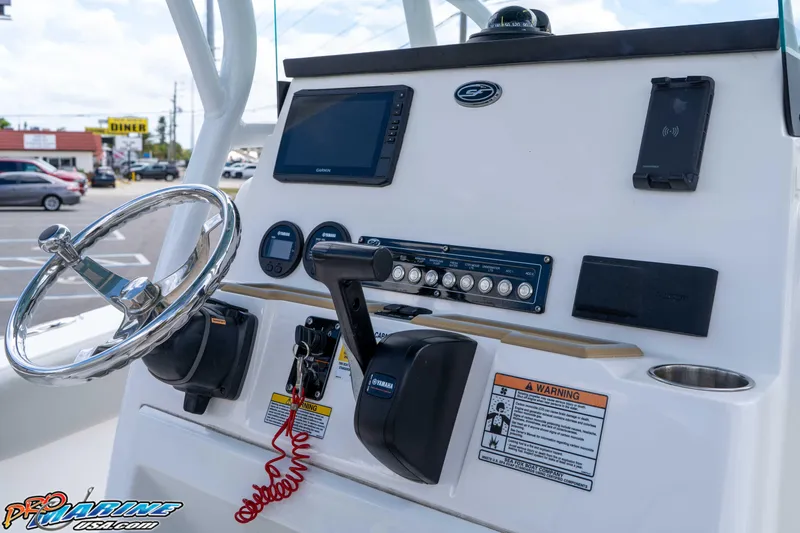 Slide: The Image of 2021 Sea Fox 228 Commander helm with steering wheel, controls, and navigation display. - 35
