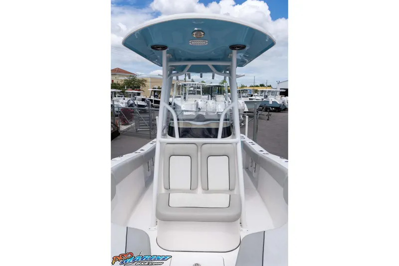Slide: The Image of 2021 Sea Fox 228 Commander boat with T-top and seating, displayed outdoors. - 37