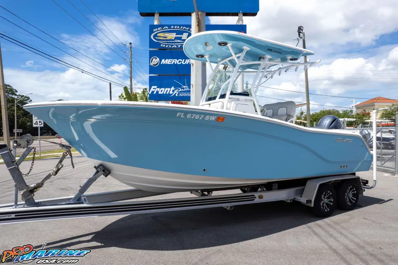 Slide: The Image of 2021 Sea Fox 228 Commander boat on trailer, displayed outdoors under clear sky. - 39