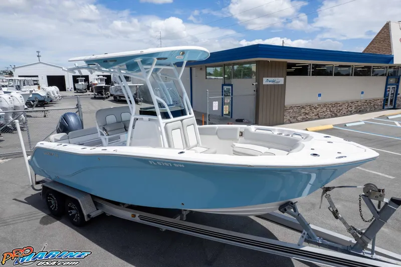 Slide: The Image of 2021 Sea Fox 228 Commander boat on trailer, displayed at a dealership under a partly cloudy sky. - 44