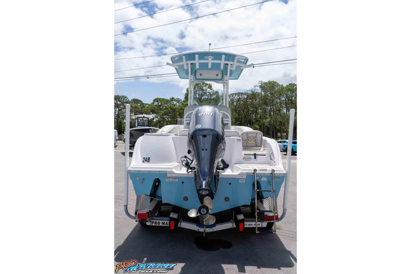 Slide: The Image of 2021 Sea Fox 228 Commander boat, rear view with outboard motor, parked outdoors. - 5