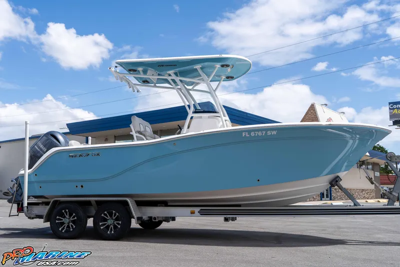Slide: The Image of 2021 Sea Fox 228 Commander boat on trailer under blue sky. - 6