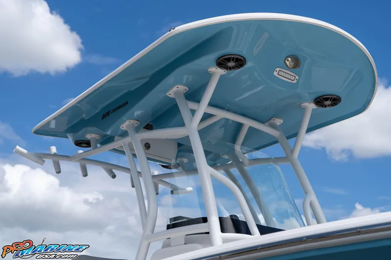 Slide: The Image of 2021 Sea Fox 228 Commander boat with blue T-top against a cloudy sky. - 8