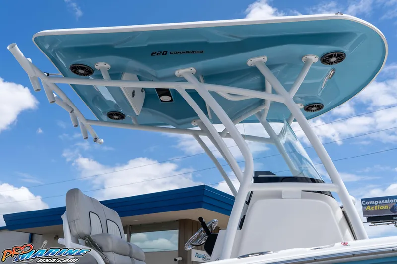 Slide: The Image of 2021 Sea Fox 228 Commander boat with T-top against blue sky background. - 9