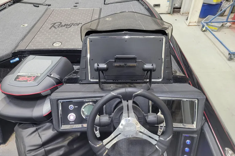 Slide: The Image of 2025 Ranger Z520R Cup-Equipped boat dashboard with steering wheel and control panel. - 10