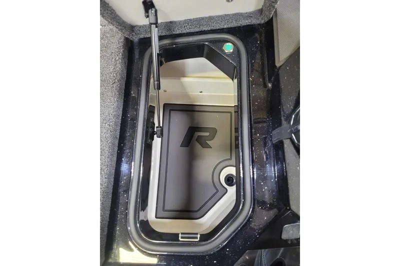 Slide: The Image of 2025 Ranger Z520R Cup-Equipped storage compartment with hydraulic lift and sleek interior design. - 12