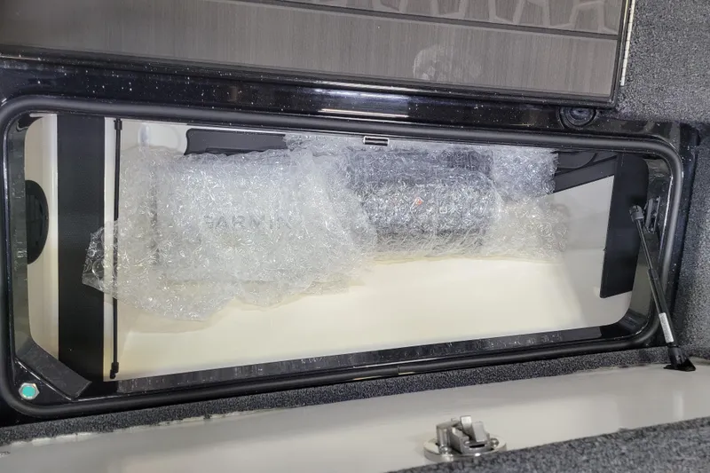 Slide: The Image of 2025 Ranger Z520R Cup-Equipped storage compartment with bubble-wrapped contents. - 13