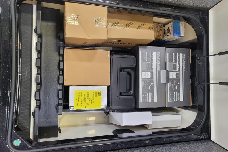 Slide: The Image of Storage compartment of 2025 Ranger Z520R Cup-Equipped, filled with various boxes and equipment. - 15